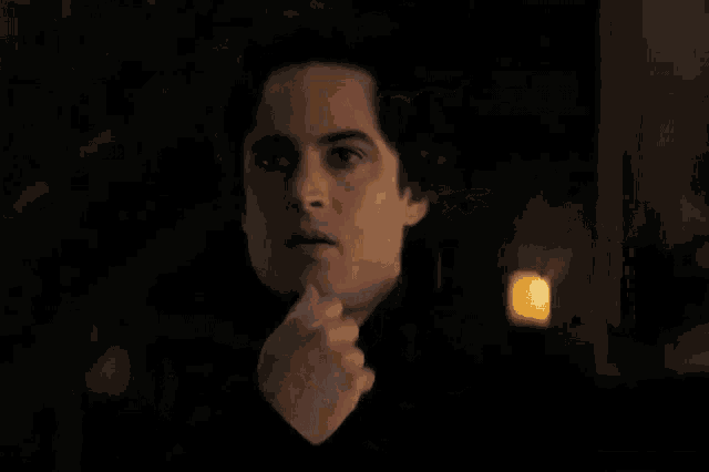 a close up of a man 's face in the dark