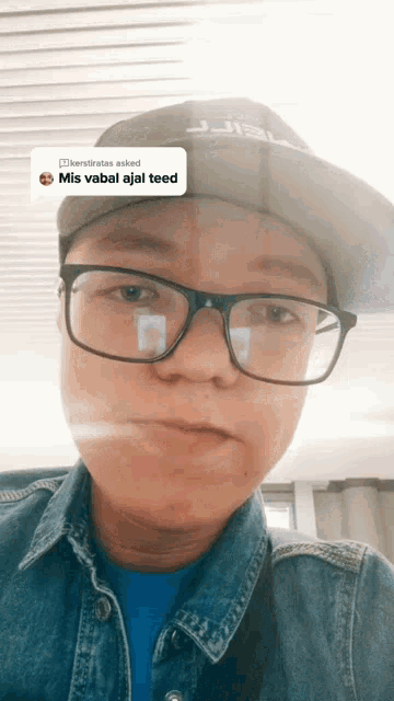 a person wearing glasses and a hat with the word mis written on the bottom