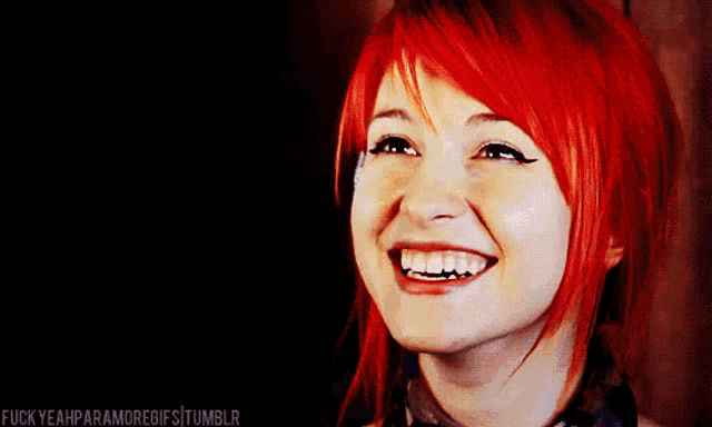 a woman with red hair is smiling with the words fuckyeahparamoregifs tumblr visible