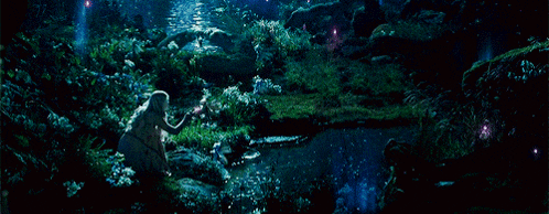 a woman sits on a rock in a lush green forest at night