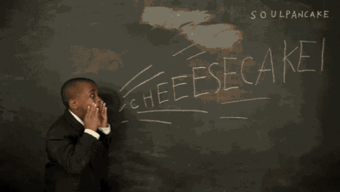 a young boy in a suit and tie is standing in front of a blackboard that says soul pancake