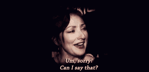 a woman is laughing with her eyes closed and says `` um , sorry ! can i say that ? ''
