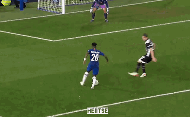 a soccer player wearing number 20 kicks the ball into the goal