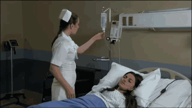 a nurse is putting an iv into a patient 's arm