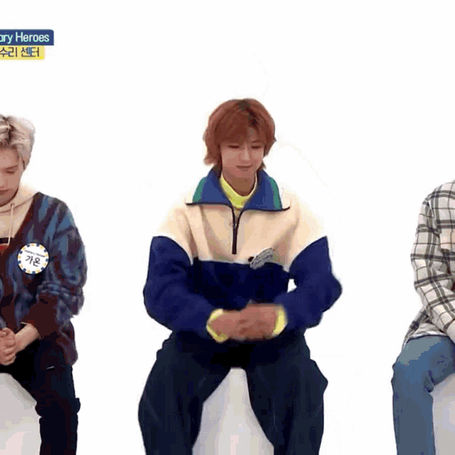 a group of young men are sitting in front of a white background with a sticker that says ' diary heroes ' on it