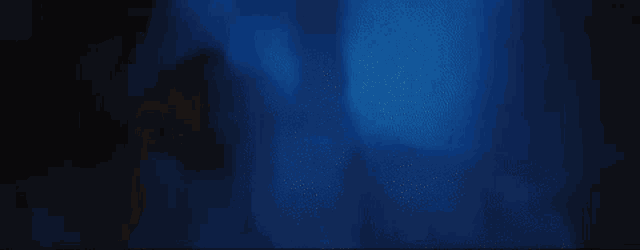 a blurry picture of a person 's face in the dark