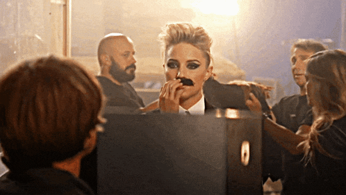 a woman with a mustache on her face is getting her makeup done