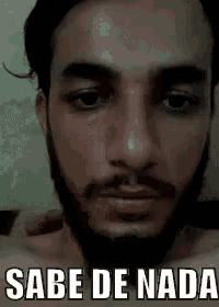 a man with a beard is making a funny face with the words `` sabe de nada '' .