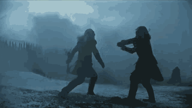 a couple of people standing in the snow with swords in their hands
