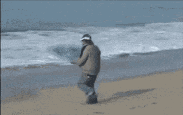 a person riding a surfboard on a beach with the number 1 on the back