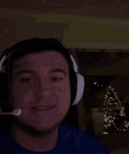 a man wearing headphones is making a funny face .