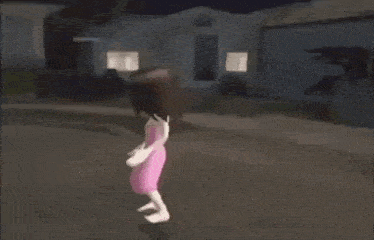 a girl in a pink dress is standing in front of a house