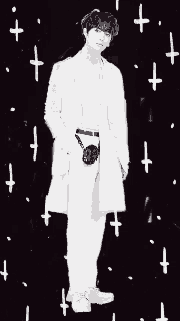 a black and white photo of a man in a white coat with a camera on his belt