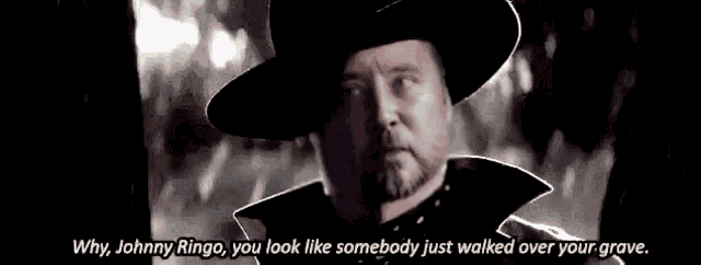 a black and white photo of a man in a cowboy hat with a quote .