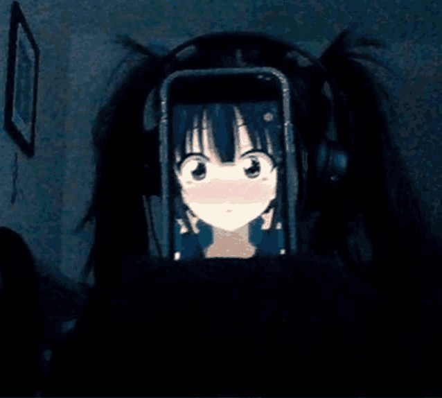 a girl wearing headphones is looking at a picture of a girl on her phone .