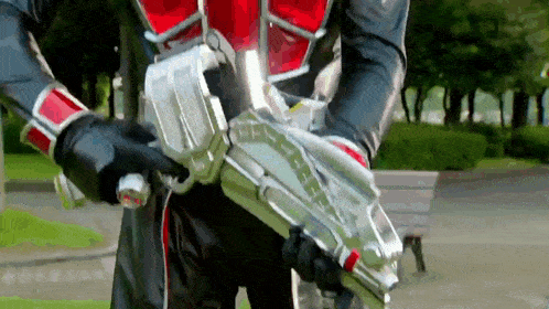 a person in a superhero costume is holding a gun
