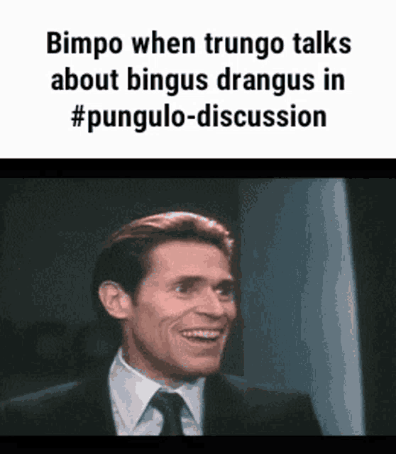 a man in a suit and tie is smiling while talking about bingus drangus in #punulo-discussion