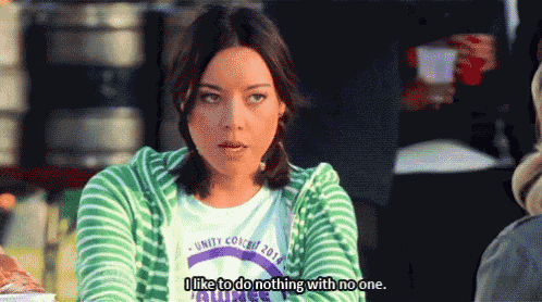 a woman in a green and white striped shirt is saying i like to do nothing with no one