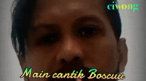 a close up of a man 's face with the words main cantik boscuu in the corner