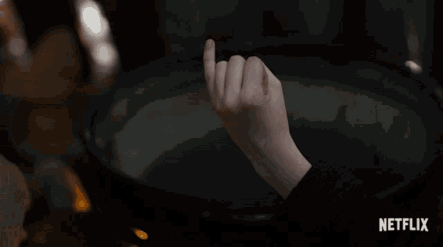 two people holding hands with the netflix logo in the corner