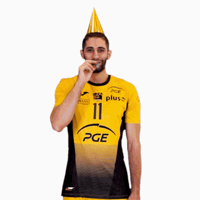 a man wearing a yellow and black pge shirt