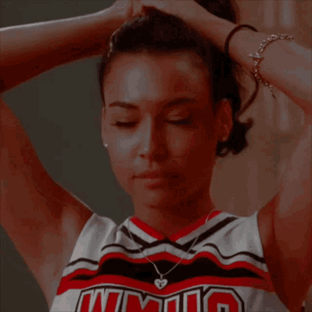 a cheerleader wearing a jersey that says nm on it