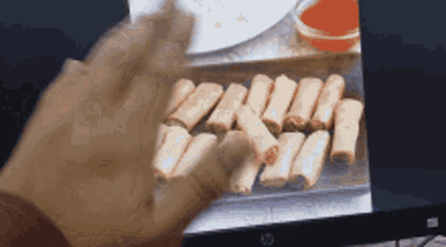 a person is touching a screen with a picture of food