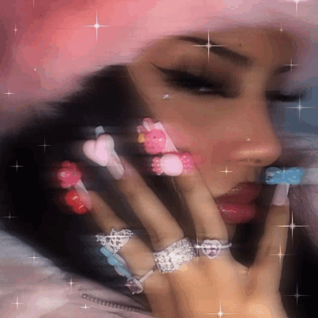 a woman wearing a pink hat and a bunch of rings