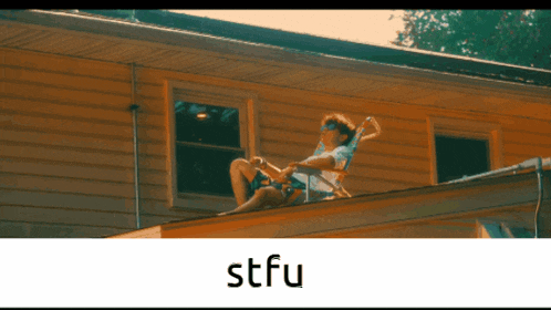 a man in a chair on the roof of a house with stfu written on the bottom