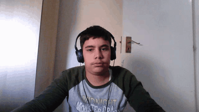 a boy wearing headphones and a shirt that says midnight on it