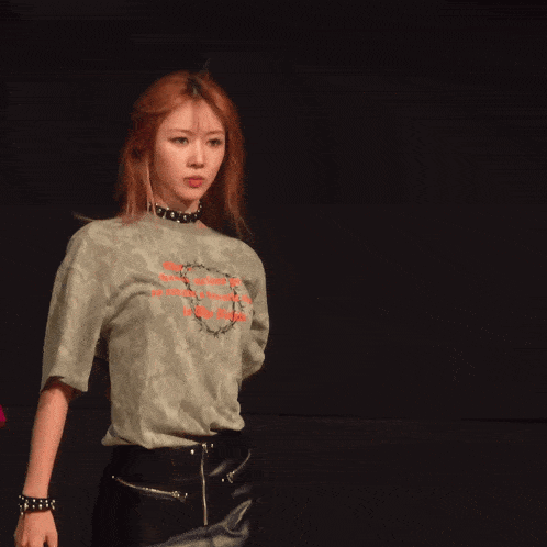 a woman wearing a t-shirt that says ' i love you ' on it is smiling