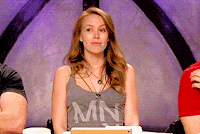 a woman wearing a tank top that says mn