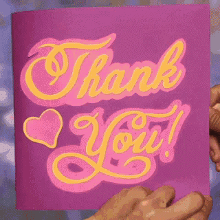 a person is holding a purple thank you card with a pink heart on it