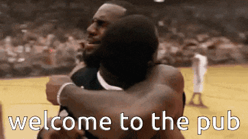 two men hugging on a basketball court with the words welcome to the pub