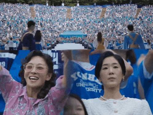 a woman in a university shirt stands in front of a large crowd of people