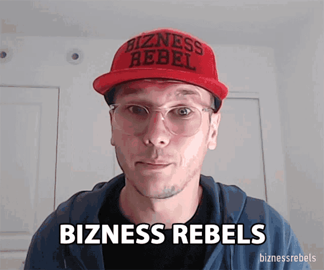 a man wearing a red hat that says bizness rebels on it