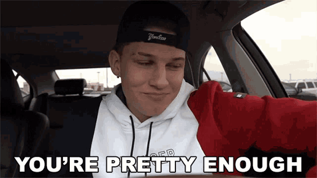a man in a car with the words you 're pretty enough