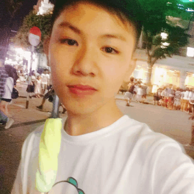 a young man taking a selfie in front of a no entry sign