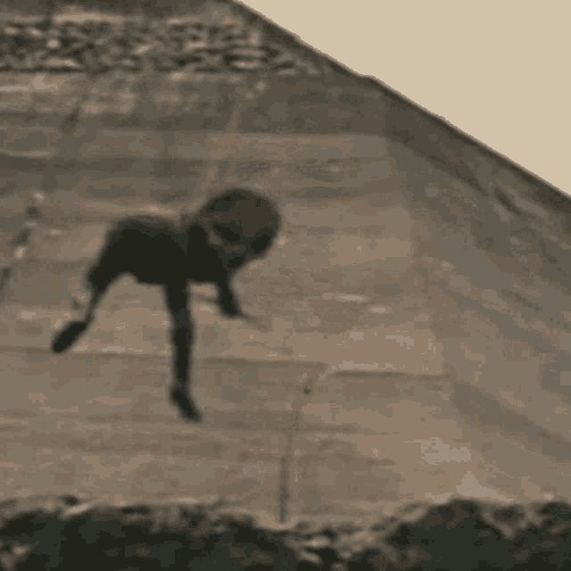 a man is standing on top of a concrete surface .
