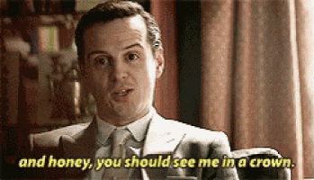 a man in a suit and tie is sitting in a chair talking to another man .