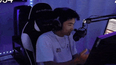 a man wearing headphones is sitting in front of a computer and says no ingredients
