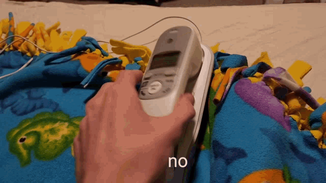 a person is ironing a blanket and the word no is visible