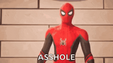 a man in a spiderman suit is standing in front of a brick wall .