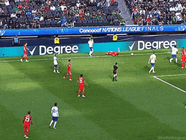 a soccer game is being played in a stadium with a degree banner