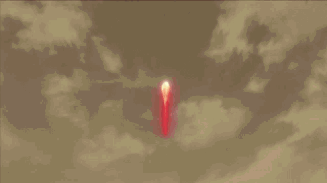 a close up of a cartoon character 's eyes with a flame behind them