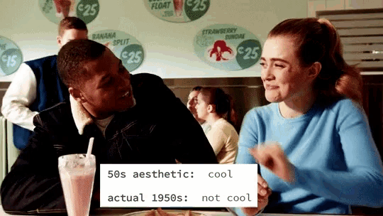 a man and a woman are sitting at a table in a diner talking to each other
