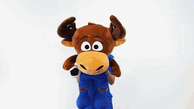 a woman in a blue jersey is holding a stuffed animal