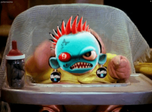a baby in a high chair with a sticker that says sloth