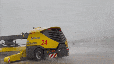 a yellow and black vehicle with the number 24 on the back