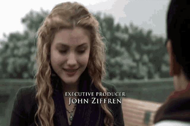 a woman in a purple scarf is smiling and the executive producer is john zifferen